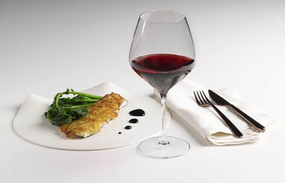 Bass filet with potato crust, red wine reduction and broccoli rabe