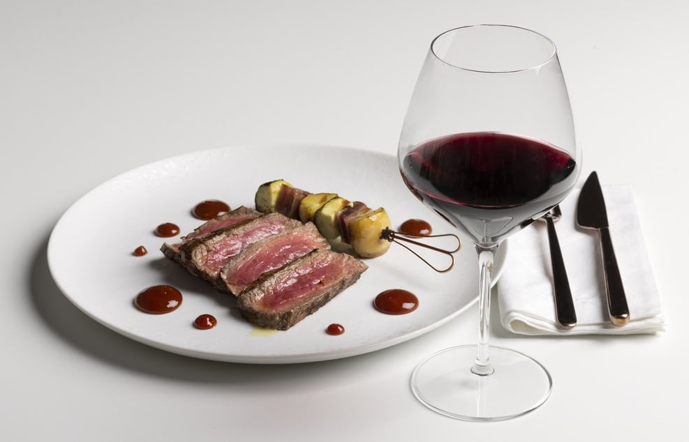 Grilled steak slice, potato and courgette skewers, BBQ sauce