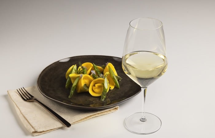 Tortelli with robiola and orange, herbed butter and asparagus