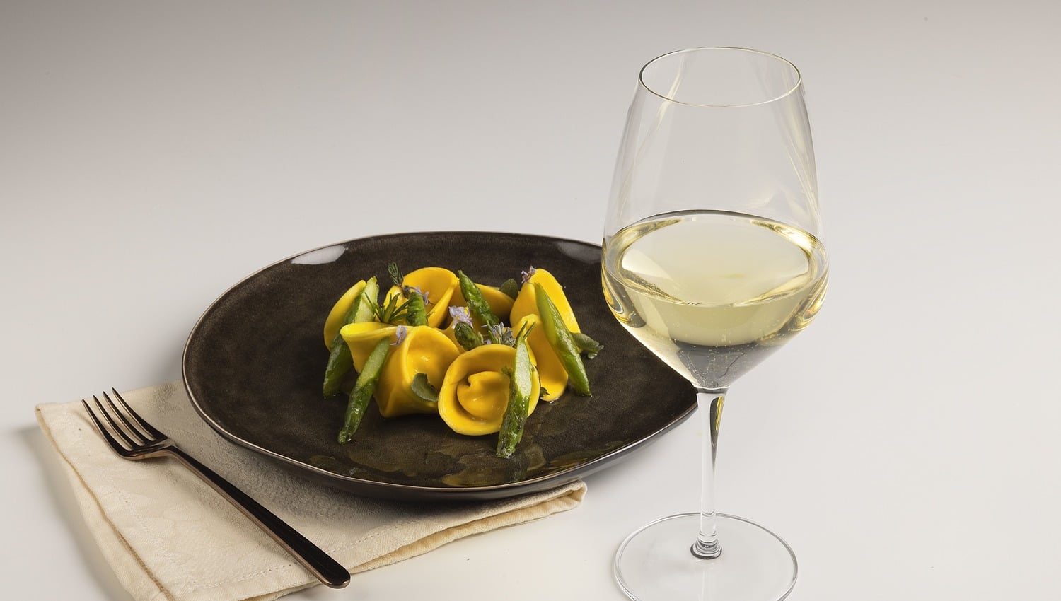 Tortelli with robiola and orange, herbed butter and asparagus