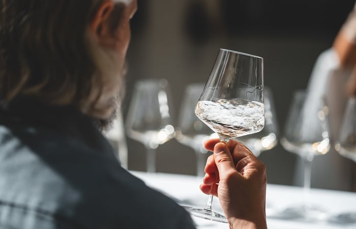 A glass of white wine is gently swirled.